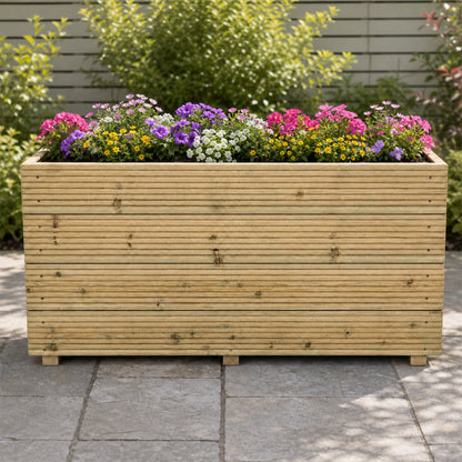 Tall 4 ft Long Wooden Decking Planter – 120 × 35 × 63 cm planted with colourful flowers