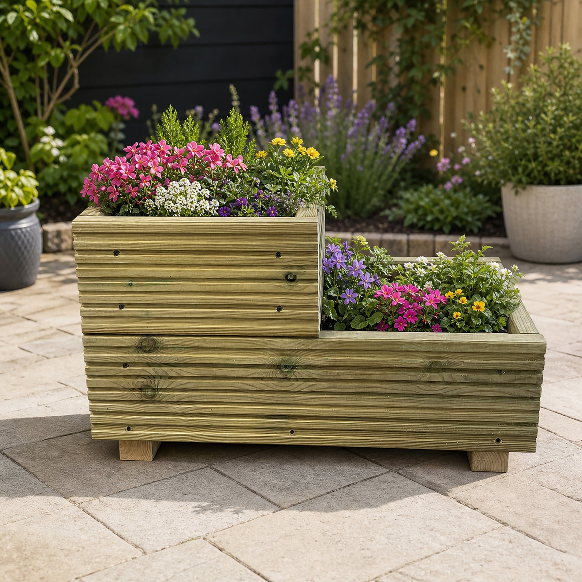 Two-tier wooden garden planter planted with colourful flowers
