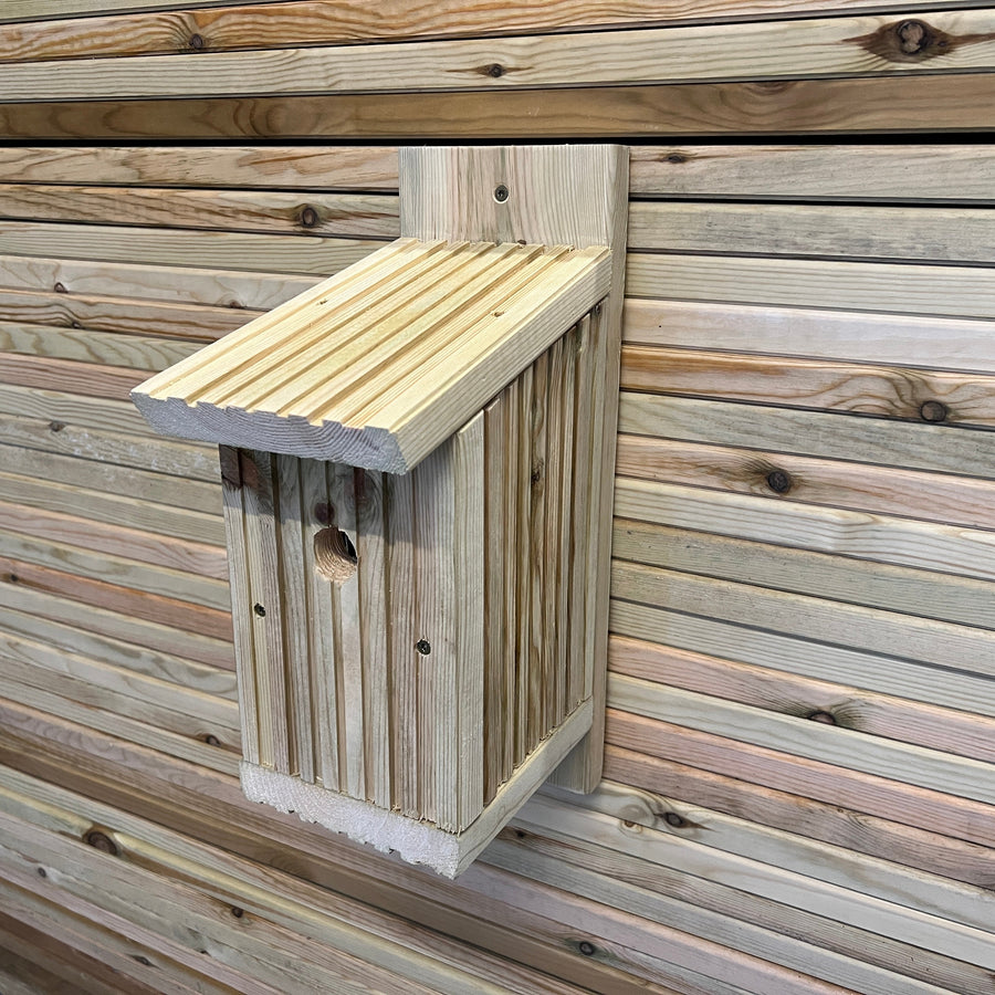 Bird nesting box showing the sloping roof and front entrance