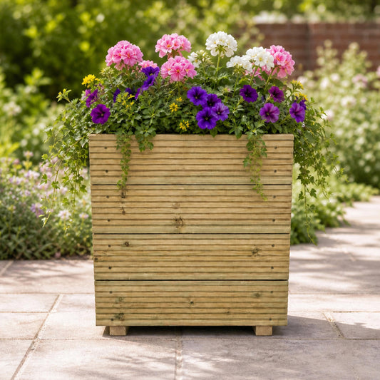 Large Square Tall Wooden Decking Planter 50 × 50 × 63 cm planted with colourful flowers
