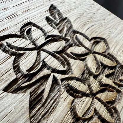 Close-up of floral clipart engraved in oak