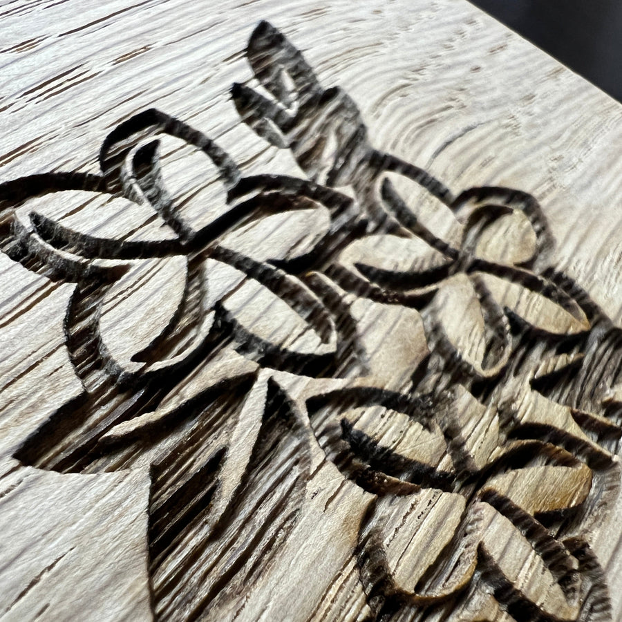 Close-up of floral clipart engraved in oak
