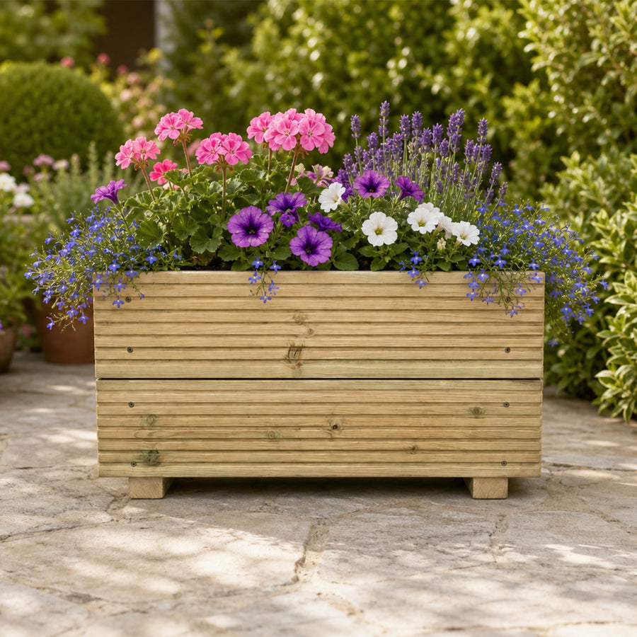 Medium Wooden Decking Planter – 57 × 35 × 33 cm planted with colourful flowers