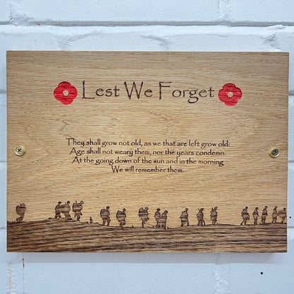 Front view of a Lest We Forget oak plaque with wall fixings