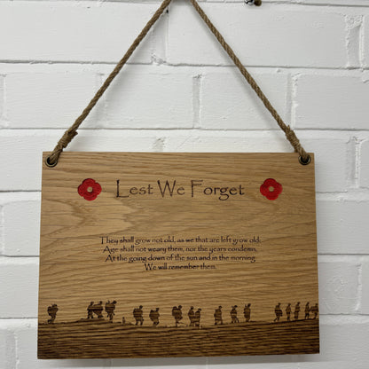 Lest We Forget oak plaque hanging from a twine cord