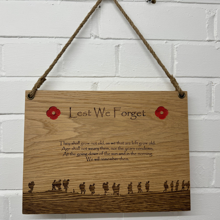 Lest We Forget oak plaque hanging from a twine cord