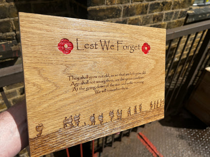 Oak remembrance plaque held outdoors showing the full engraved design