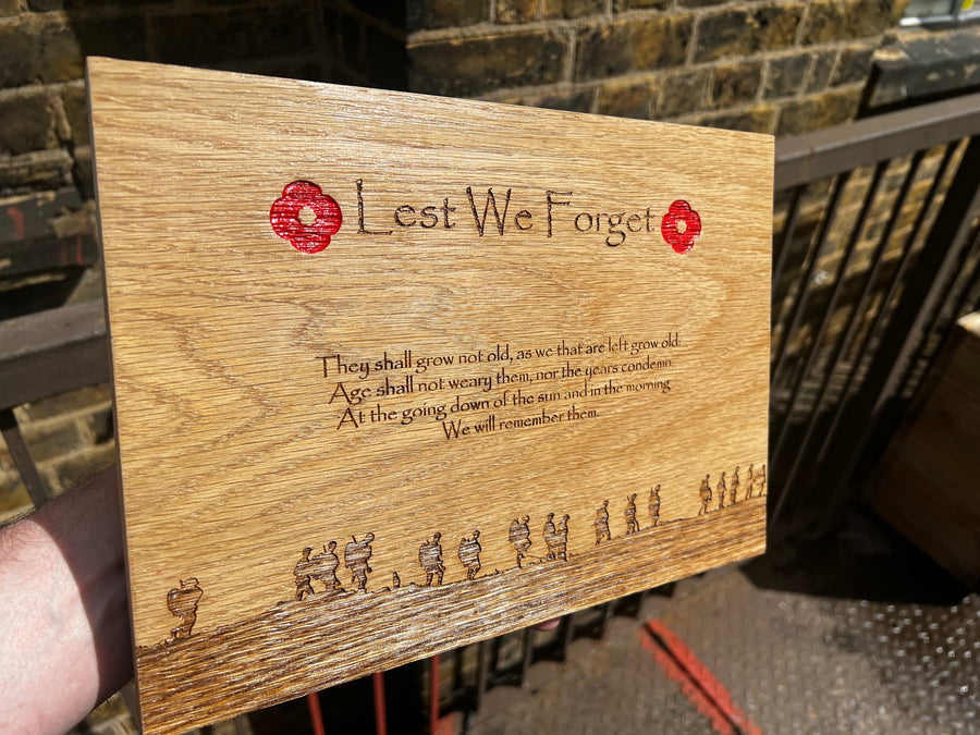 Oak remembrance plaque held outdoors showing the full engraved design