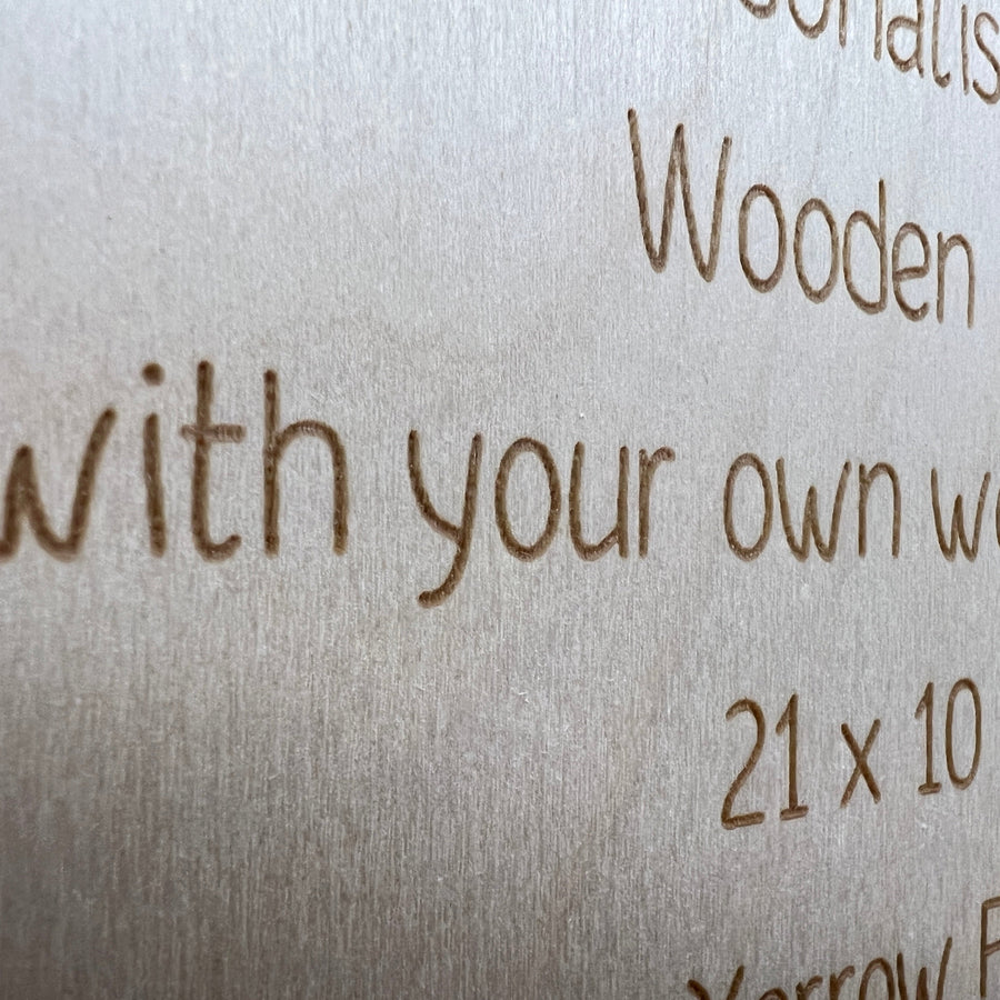 Close-up of engraved wording and natural grain on a wooden sign