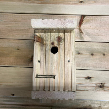 Front of a wooden nesting box with its lower opening secured