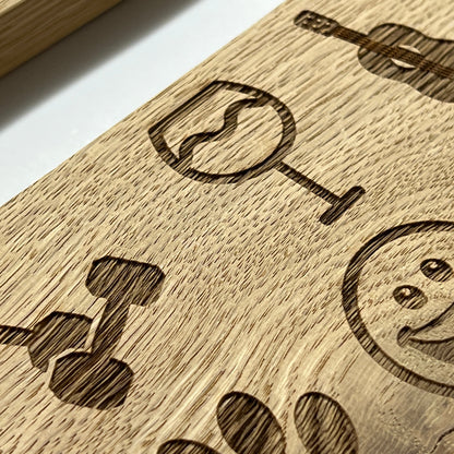 Engraved wine-glass, cocktail and smiley-face clipart on an oak plaque