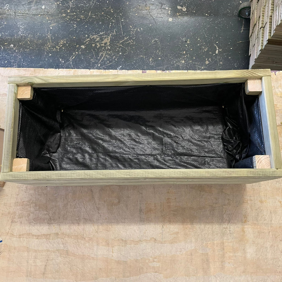 Top view of a wooden planter with its base and sides lined