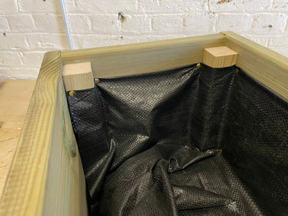 Planter liner folded around an internal wooden corner support